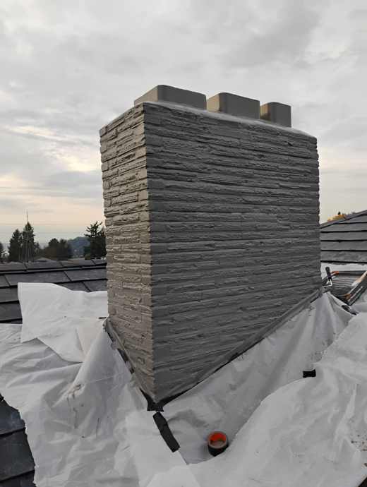 Before custom chimney cap installation showing three exposed flue liners