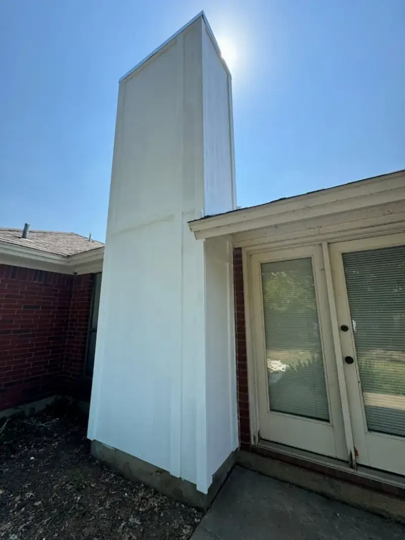 After chimney chase rebuild with siding chase cover cap caulking and paint