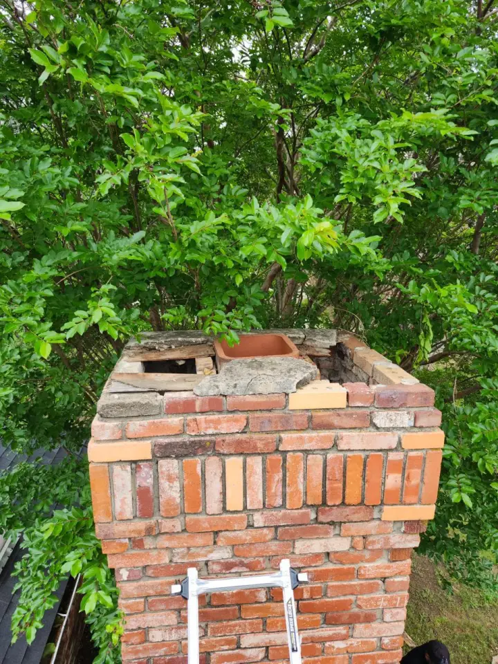 Before custom chimney cap installation showing three exposed flue liners